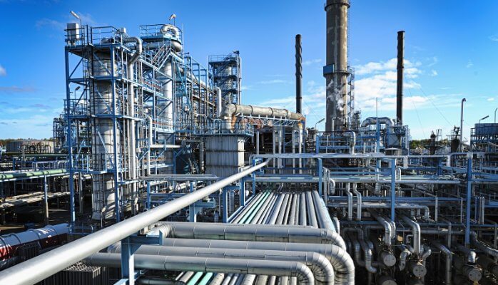 An aerial view of an energy production facility with surrounding infrastructure.