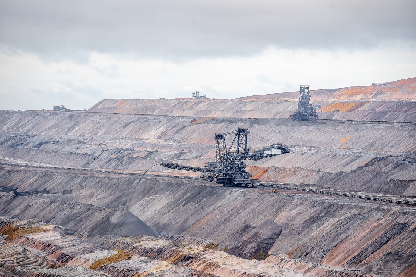 Wide-angle shot of excavation machines at Jackerath Garzweiler Skywalk, Germany, with an industrial landscape in the background.