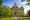 Grand historic courthouse with ornate architecture, clock tower, and lush green landscaping.